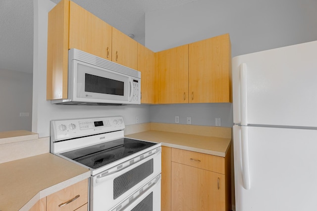 545 SW Buswell Ave, Port Saint Lucie, FL 34983 - kitchen with white appliances, light brown cabinetry, and light countertops