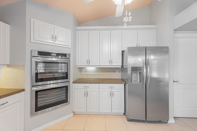 1501 SW Kamchatka Ave, Port Saint Lucie, FL 34953 - kitchen with appliances with stainless steel finishes, white cabinetry, backsplash, and vaulted ceiling