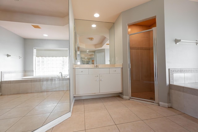 1501 SW Kamchatka Ave, Port Saint Lucie, FL 34953 - bathroom featuring vanity, tile patterned floors, a bath, a shower stall, and recessed lighting