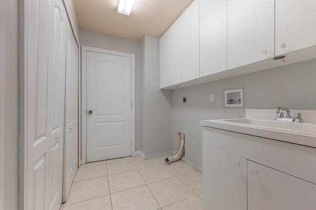 1501 SW Kamchatka Ave, Port Saint Lucie, FL 34953 - laundry room featuring hookup for an electric dryer, cabinet space, hookup for a washing machine, and light tile patterned floors