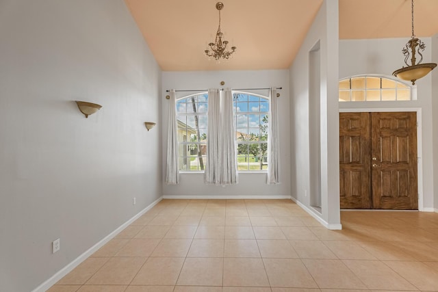 1501 SW Kamchatka Ave, Port Saint Lucie, FL 34953 - foyer with a chandelier, light tile patterned floors, and vaulted ceiling