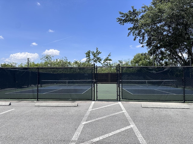 301 SW S River Dr Unit 206, Stuart, FL 34997 - view of tennis court with a gate