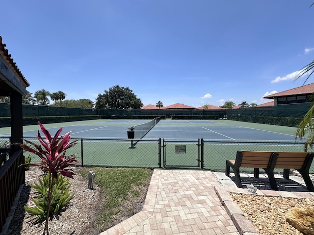 301 SW S River Dr Unit 206, Stuart, FL 34997 - view of tennis court featuring a gate and community basketball court