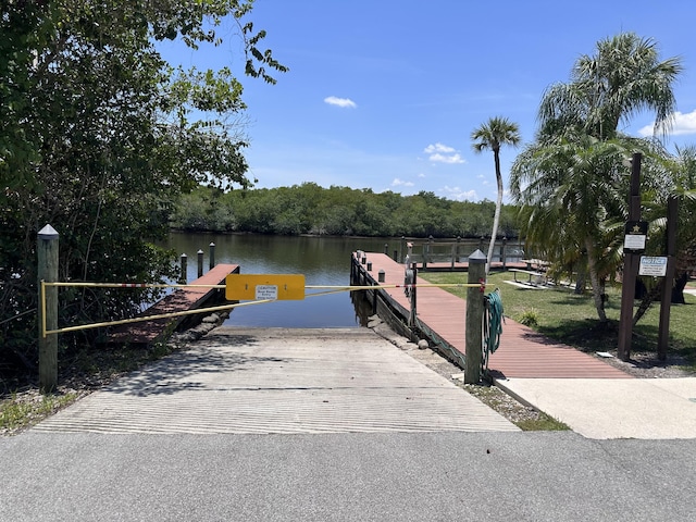 301 SW S River Dr Unit 206, Stuart, FL 34997 - dock area featuring a boat ramp and a water view