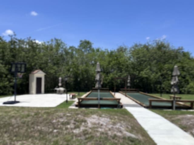 301 SW S River Dr Unit 206, Stuart, FL 34997 - view of property's community featuring a bocce ball area and view of scattered trees