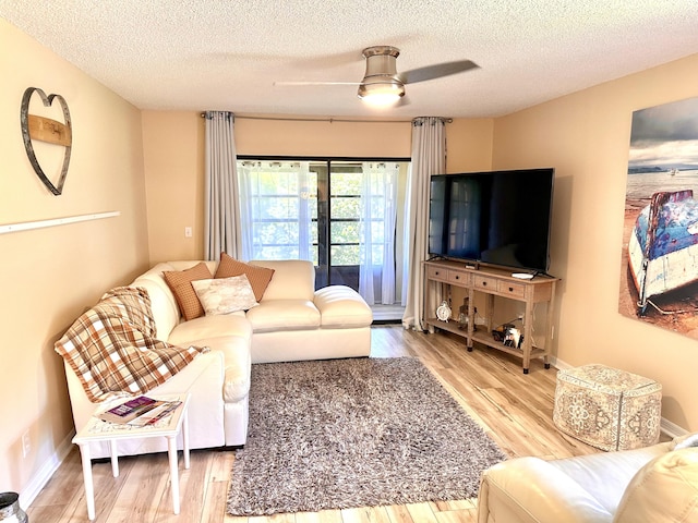 301 SW S River Dr Unit 206, Stuart, FL 34997 - living room with a textured ceiling, wood finished floors, ceiling fan, and baseboards