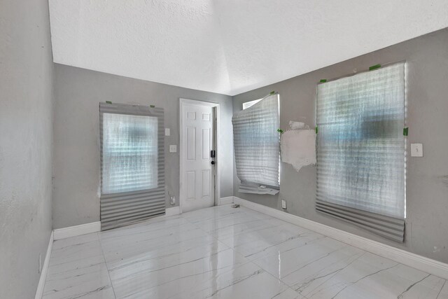 1112 S K St, Lake Worth Beach, FL 33460 - foyer featuring marble look tile flooring and baseboards