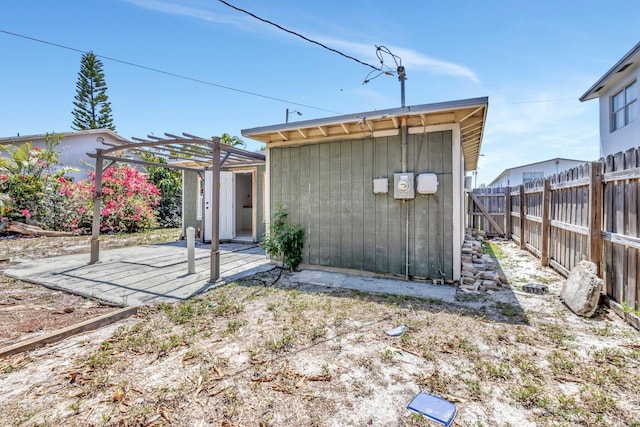 1112 S K St, Lake Worth Beach, FL 33460 - back of property with a pergola, a fenced backyard, and a patio