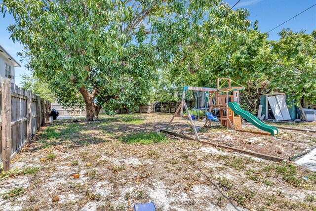 1112 S K St, Lake Worth Beach, FL 33460 - fenced backyard featuring a playground