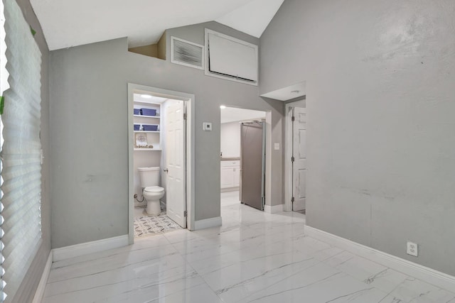 1112 S K St, Lake Worth Beach, FL 33460 - bedroom featuring light marble finish floors, baseboards, ensuite bath, and high vaulted ceiling
