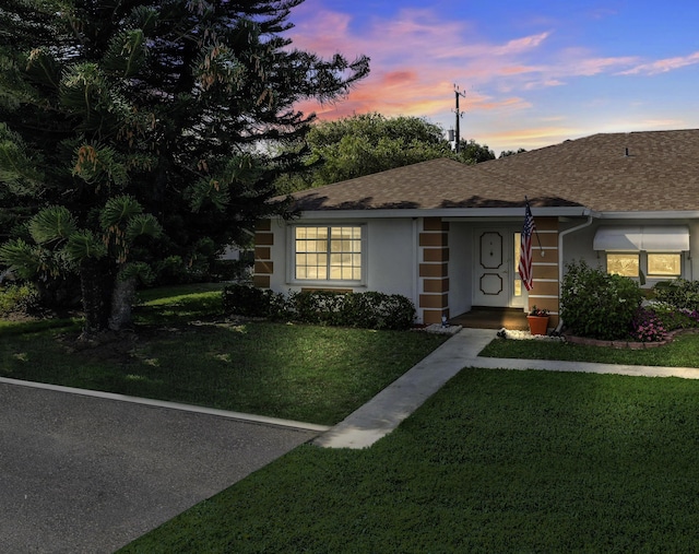 1233 S Lakes End Dr Unit A, Fort Pierce, FL 34982 - single story home with a front yard, stucco siding, and roof with shingles