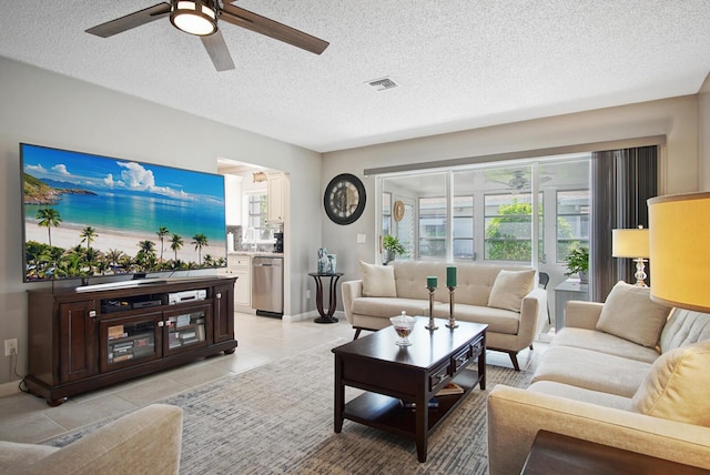 1233 S Lakes End Dr Unit A, Fort Pierce, FL 34982 - living room with a ceiling fan, a textured ceiling, light tile patterned floors, and baseboards
