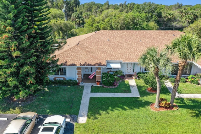 1233 S Lakes End Dr Unit A, Fort Pierce, FL 34982 - view of front of home with a front lawn and a view of trees