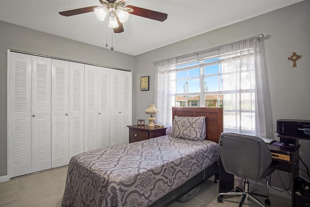 1233 S Lakes End Dr Unit A, Fort Pierce, FL 34982 - bedroom with light tile patterned floors, a closet, ceiling fan, a desk, and a textured ceiling