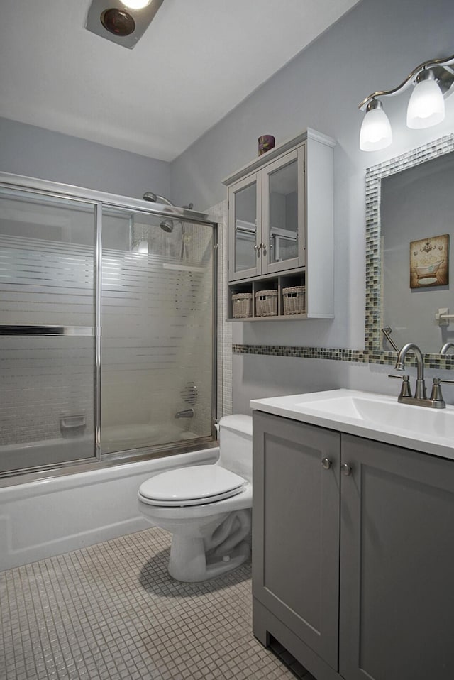 1233 S Lakes End Dr Unit A, Fort Pierce, FL 34982 - bathroom featuring toilet, shower / bath combination with glass door, vanity, and tile patterned flooring