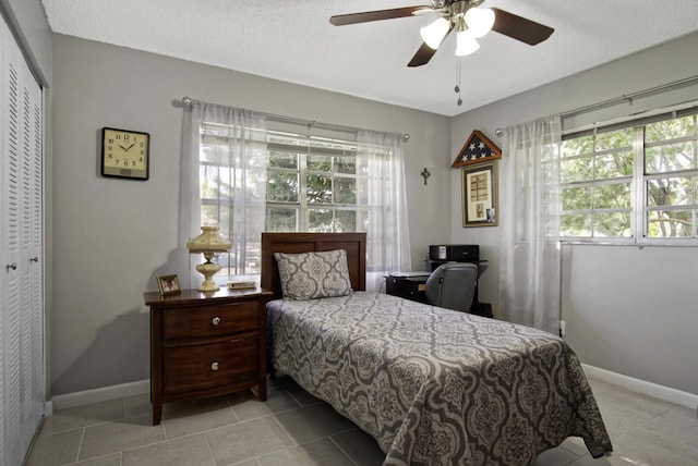 1233 S Lakes End Dr Unit A, Fort Pierce, FL 34982 - bedroom featuring multiple windows, a closet, baseboards, and ceiling fan