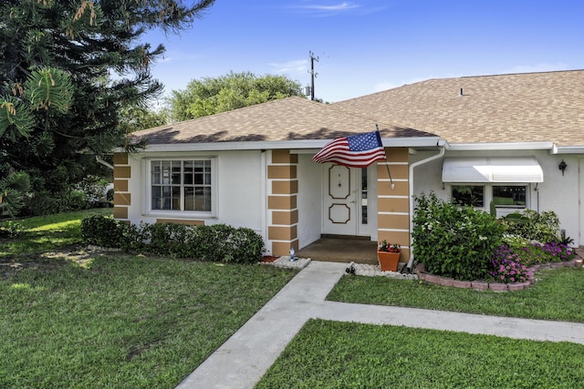 1233 S Lakes End Dr Unit A, Fort Pierce, FL 34982 - single story home with a shingled roof, a front lawn, and stucco siding