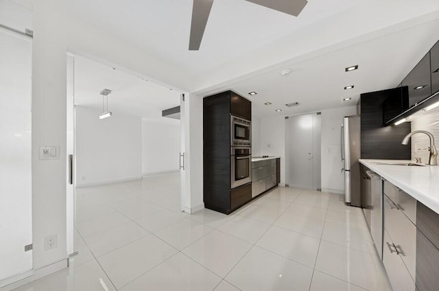 2200 S Ocean Blvd Unit 606, Delray Beach, FL 33483 - kitchen with modern cabinets, a sink, stainless steel appliances, light countertops, and a ceiling fan