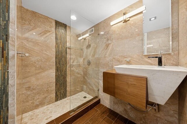 2200 S Ocean Blvd Unit 606, Delray Beach, FL 33483 - full bathroom with tile walls, walk in shower, and vanity
