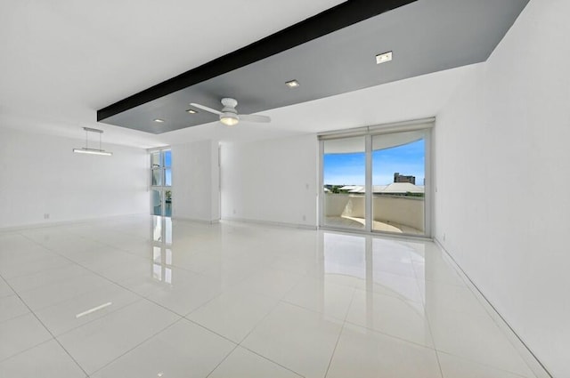 2200 S Ocean Blvd Unit 606, Delray Beach, FL 33483 - tiled empty room featuring healthy amount of natural light, a ceiling fan, baseboards, and beam ceiling