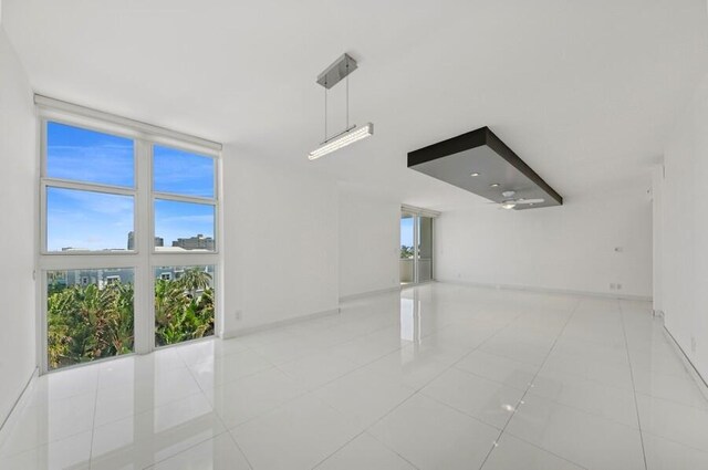 2200 S Ocean Blvd Unit 606, Delray Beach, FL 33483 - spare room featuring light tile patterned floors and baseboards