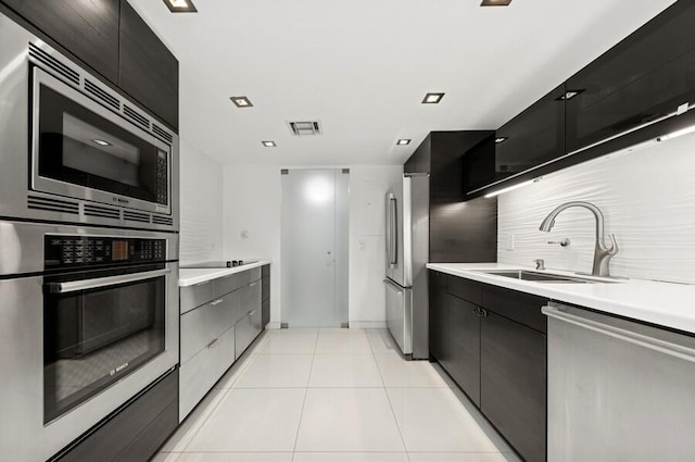 2200 S Ocean Blvd Unit 606, Delray Beach, FL 33483 - kitchen featuring stainless steel appliances, backsplash, light countertops, modern cabinets, and a sink