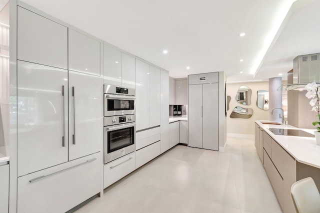 875 E Camino Real Unit 2G, Boca Raton, FL 33432 - kitchen with modern cabinets, paneled refrigerator, a sink, double oven, and black electric stovetop