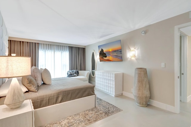 875 E Camino Real Unit 2G, Boca Raton, FL 33432 - bedroom featuring baseboards and concrete flooring