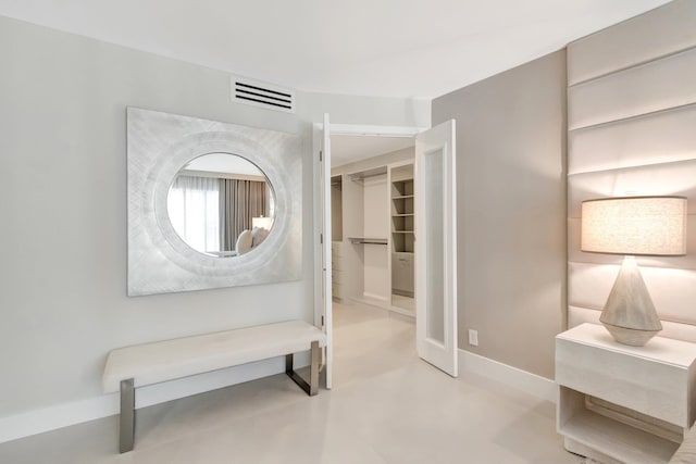875 E Camino Real Unit 2G, Boca Raton, FL 33432 - hall featuring concrete floors and baseboards