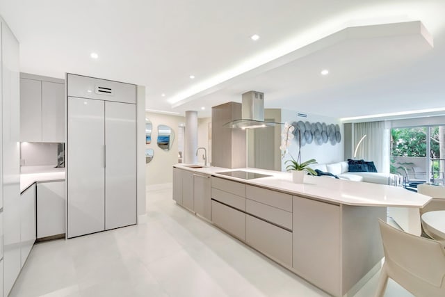 875 E Camino Real Unit 2G, Boca Raton, FL 33432 - kitchen featuring modern cabinets, island range hood, open floor plan, light countertops, and a large island with sink