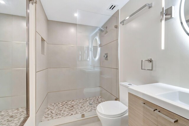 875 E Camino Real Unit 2G, Boca Raton, FL 33432 - bathroom featuring a stall shower, toilet, vanity, and recessed lighting