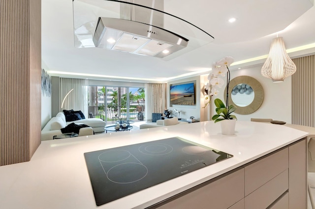 875 E Camino Real Unit 2G, Boca Raton, FL 33432 - kitchen featuring black electric stovetop, open floor plan, light countertops, ventilation hood, and recessed lighting