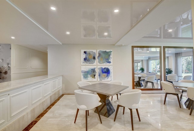 875 E Camino Real Unit 2G, Boca Raton, FL 33432 - dining space with light marble finish floors, recessed lighting, inlaid floor details, and baseboards