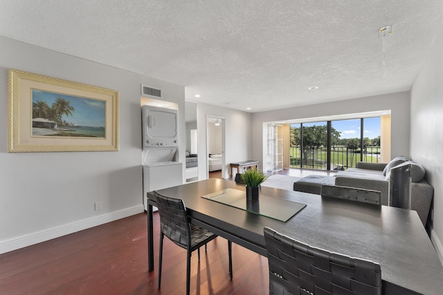 4489 Luxemburg Ct Unit 306, Lake Worth, FL 33467 - dining space featuring stacked washer / dryer, a textured ceiling, dark wood-style flooring, baseboards, and recessed lighting