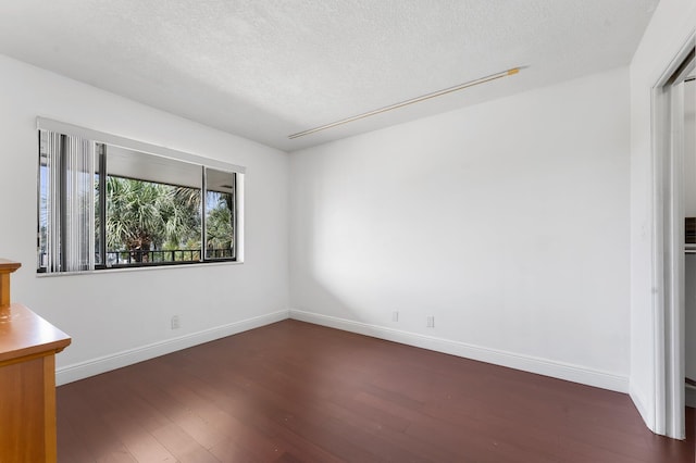 4489 Luxemburg Ct Unit 306, Lake Worth, FL 33467 - unfurnished room featuring wood finished floors, a textured ceiling, and baseboards