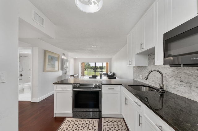 4489 Luxemburg Ct Unit 306, Lake Worth, FL 33467 - kitchen with stainless steel appliances, a sink, a peninsula, and white cabinets