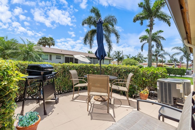 2822 Crosley Dr W Unit D, West Palm Beach, FL 33415 - view of patio / terrace with central AC and outdoor dining space