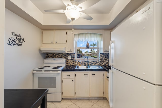 2822 Crosley Dr W Unit D, West Palm Beach, FL 33415 - kitchen featuring white appliances, under cabinet range hood, a sink, dark countertops, and tasteful backsplash