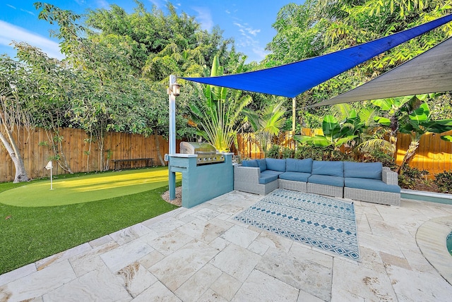 2590 Monaco Ter, Palm Beach Gardens, FL 33410 - fenced backyard with a patio, an outdoor living space, and a putting green