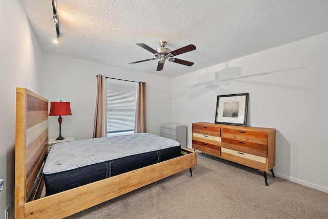2590 Monaco Ter, Palm Beach Gardens, FL 33410 - bedroom with carpet, a textured ceiling, rail lighting, ceiling fan, and baseboards