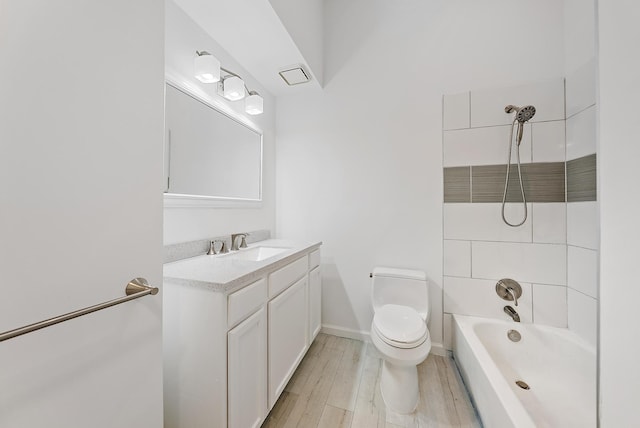 2590 Monaco Ter, Palm Beach Gardens, FL 33410 - bathroom with toilet, vanity, shower / washtub combination, wood finished floors, and baseboards