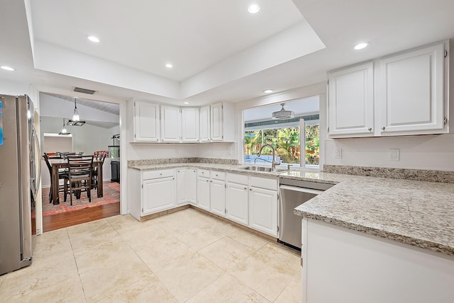 2590 Monaco Ter, Palm Beach Gardens, FL 33410 - kitchen featuring appliances with stainless steel finishes, a tray ceiling, a sink, white cabinetry, and recessed lighting