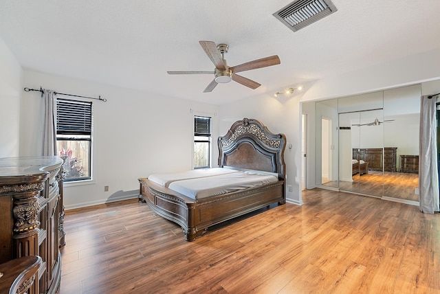 2590 Monaco Ter, Palm Beach Gardens, FL 33410 - bedroom featuring light wood-style flooring, baseboards, and ceiling fan