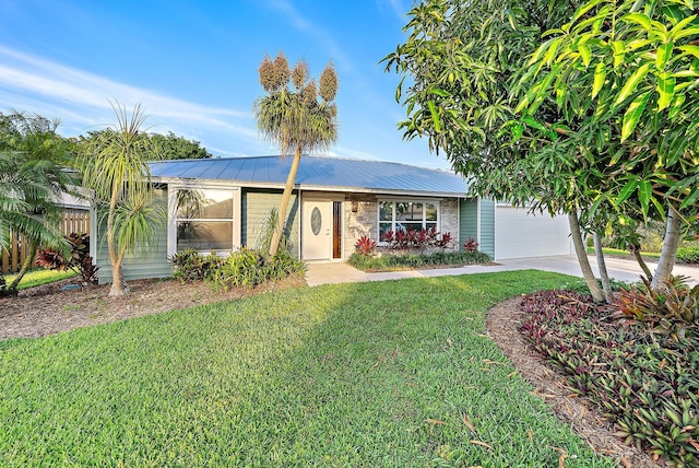 2590 Monaco Ter, Palm Beach Gardens, FL 33410 - ranch-style home with a front lawn, concrete driveway, a garage, and metal roof