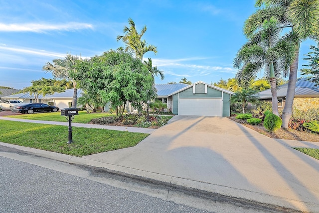 2590 Monaco Ter, Palm Beach Gardens, FL 33410 - view of property hidden behind natural elements featuring a front lawn, concrete driveway, and a garage