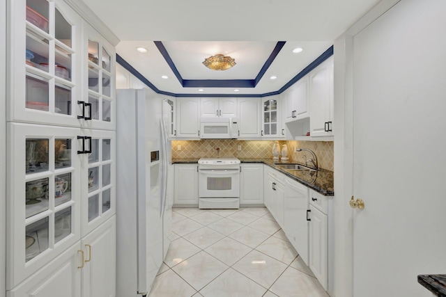 4100 Galt Ocean Dr Unit 311, Fort Lauderdale, FL 33308 - kitchen featuring white appliances, a sink, light tile patterned flooring, tasteful backsplash, and white cabinets