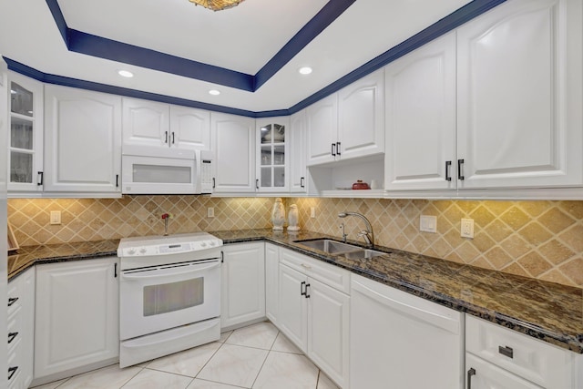 4100 Galt Ocean Dr Unit 311, Fort Lauderdale, FL 33308 - kitchen with white appliances, a sink, dark stone countertops, recessed lighting, and glass insert cabinets