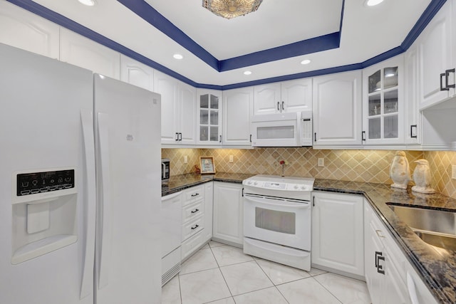 4100 Galt Ocean Dr Unit 311, Fort Lauderdale, FL 33308 - kitchen with white appliances, dark stone countertops, glass insert cabinets, white cabinetry, and recessed lighting