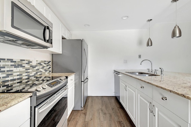 6604 66th Way, West Palm Beach, FL 33409 - kitchen with stainless steel appliances, a sink, dark wood-style flooring, decorative backsplash, and white cabinetry