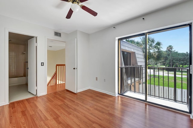 6604 66th Way, West Palm Beach, FL 33409 - unfurnished bedroom with access to exterior, light wood-type flooring, baseboards, ensuite bath, and a ceiling fan